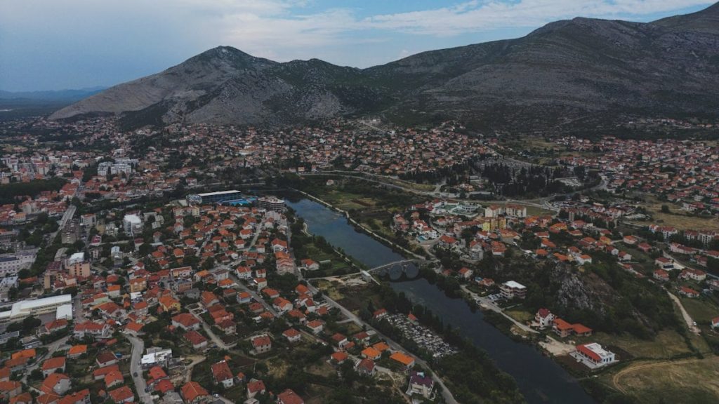 a bird's eye view of a city with mountains in the background