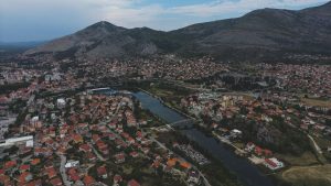 a bird's eye view of a city with mountains in the background